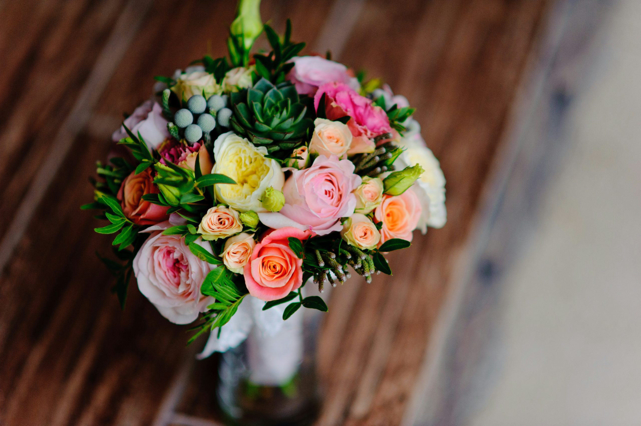 Pastel rose bouquet with succulents and greenery viewed from above