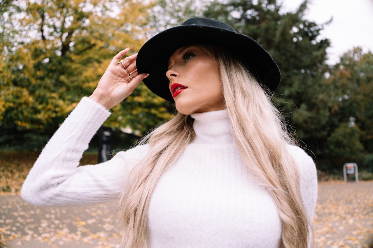 Woman in a white turtleneck and black hat outdoors