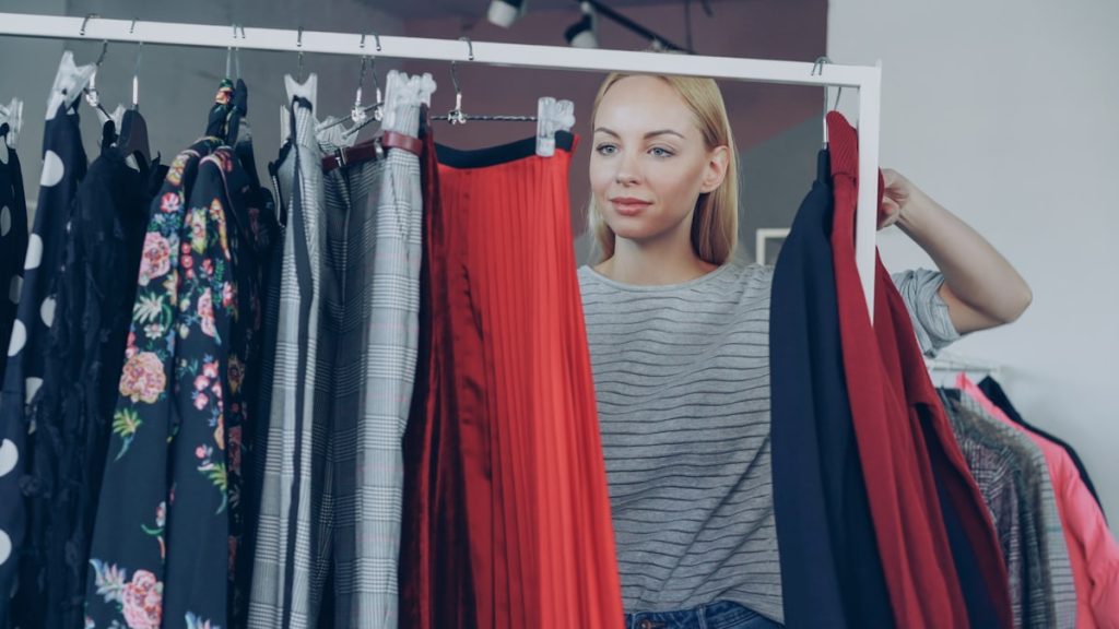 Woman choosing clothes from a clothing rack