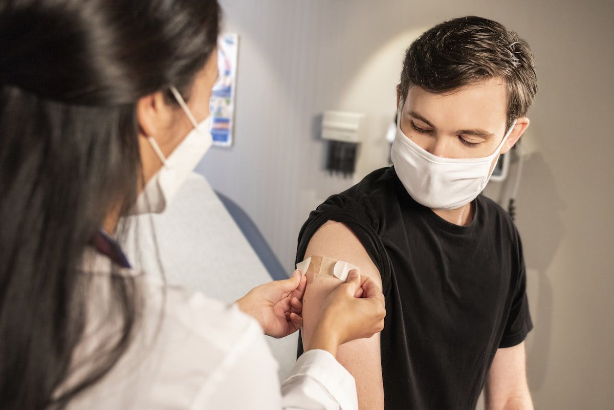 Healthcare professional applying bandage to patient