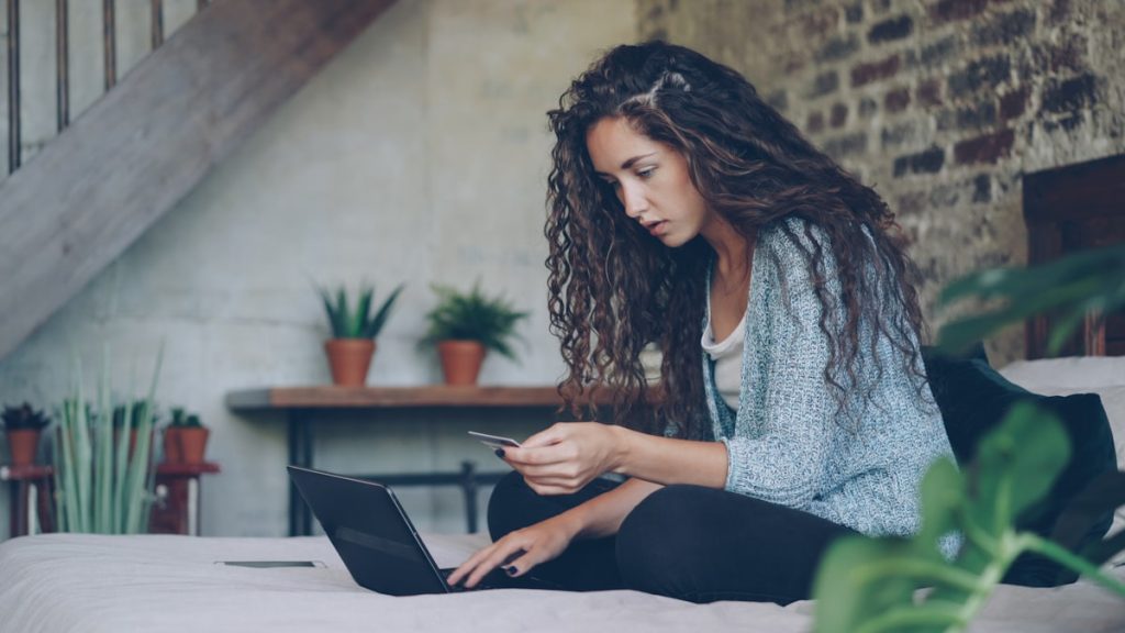Woman shopping online with laptop and credit card for health supplies
