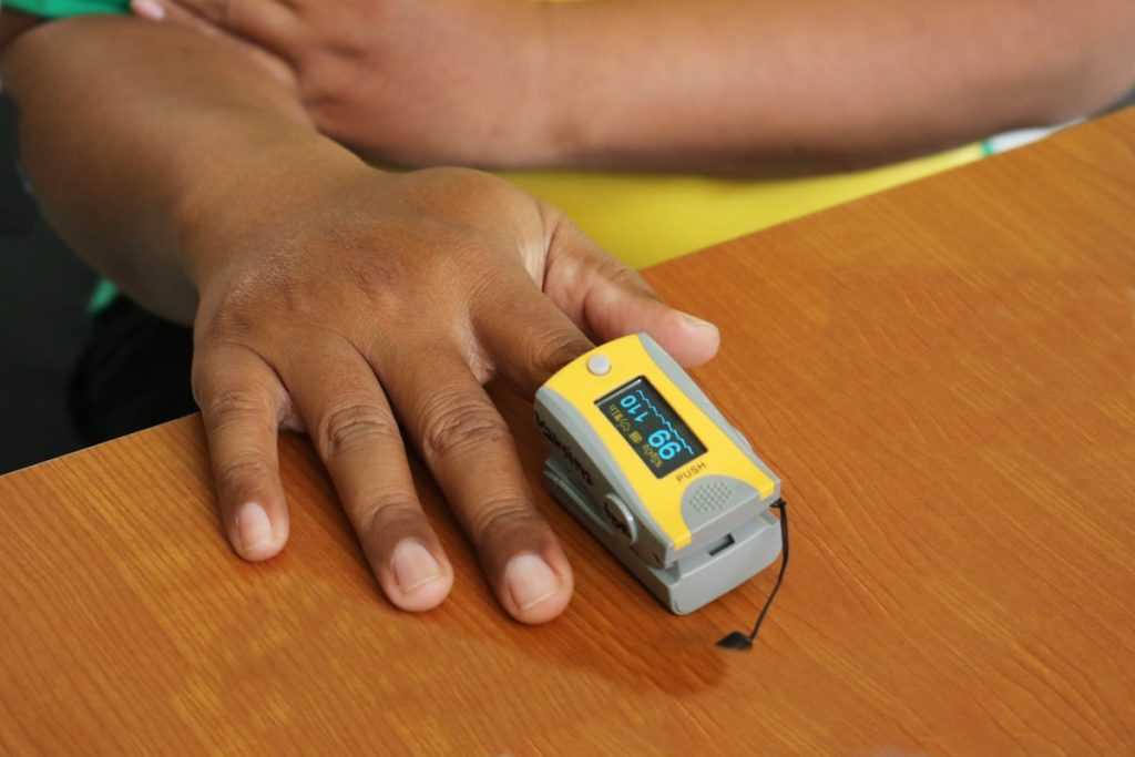 Pulse oximeter reading oxygen saturation on a finger
