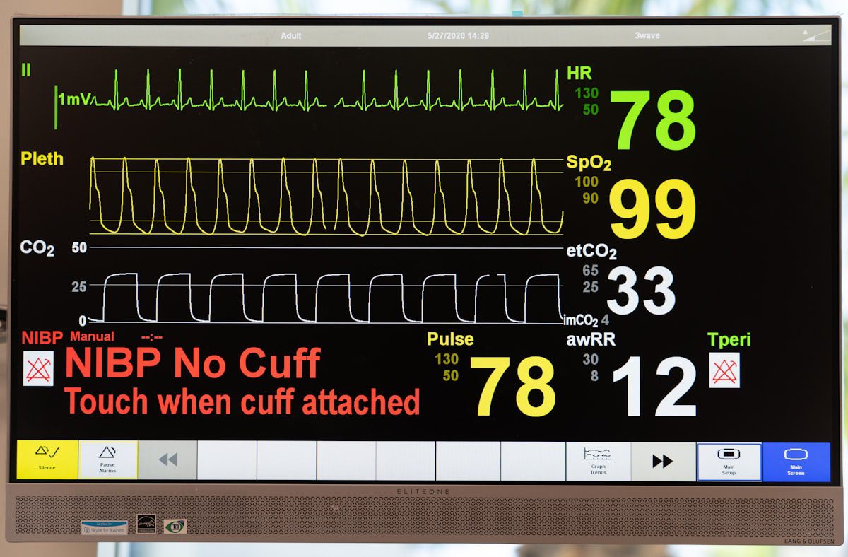 Hospital vital signs monitor displaying heart rate and oxygen levels