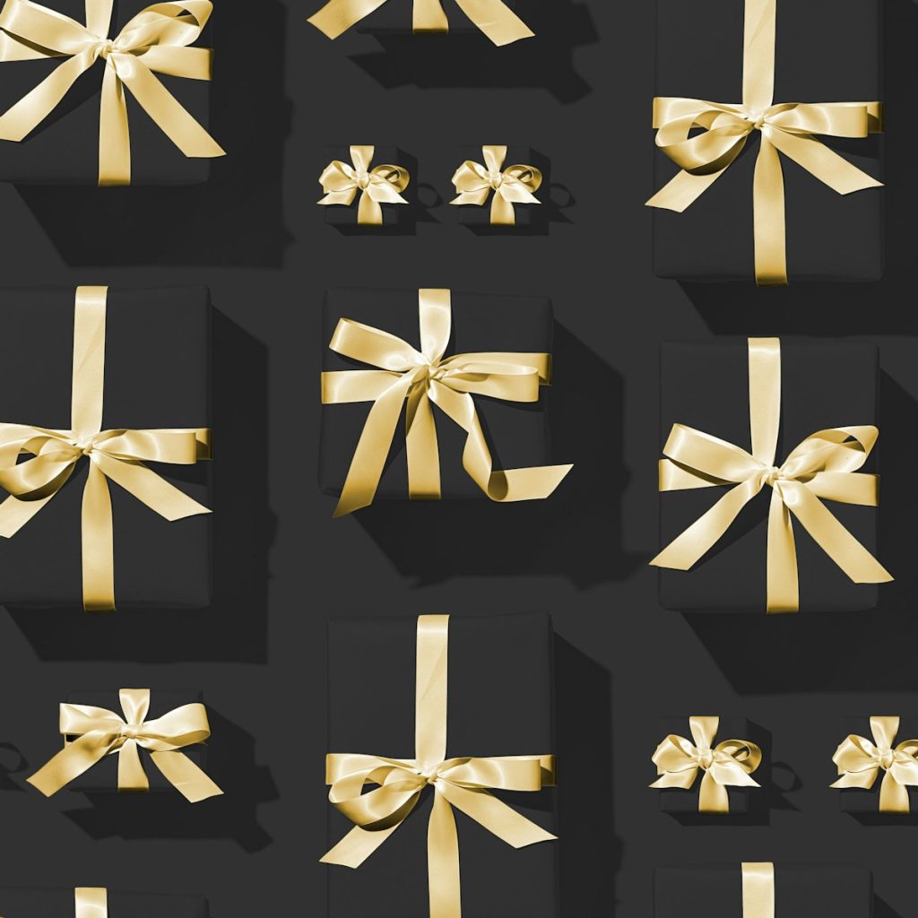 Ornate gift boxes stacked with gold ribbon