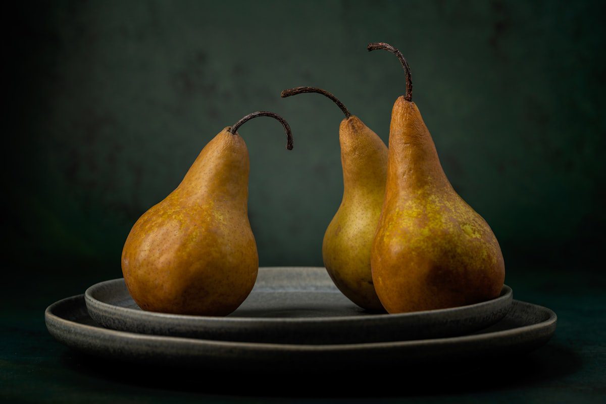A group of fresh pears on a plate