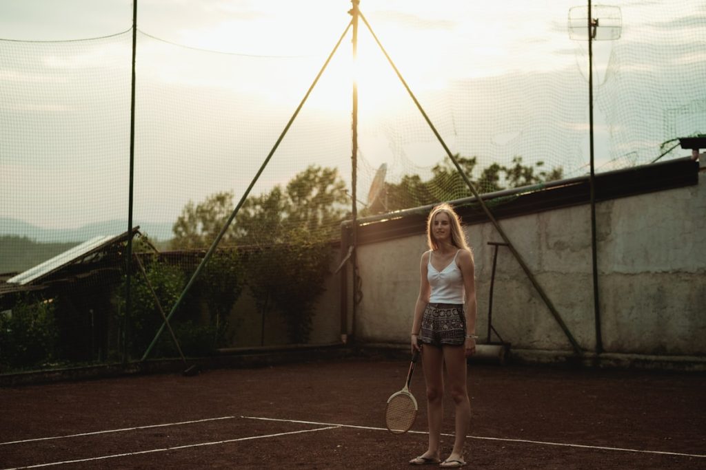 Woman holding a white tennis racket on the court