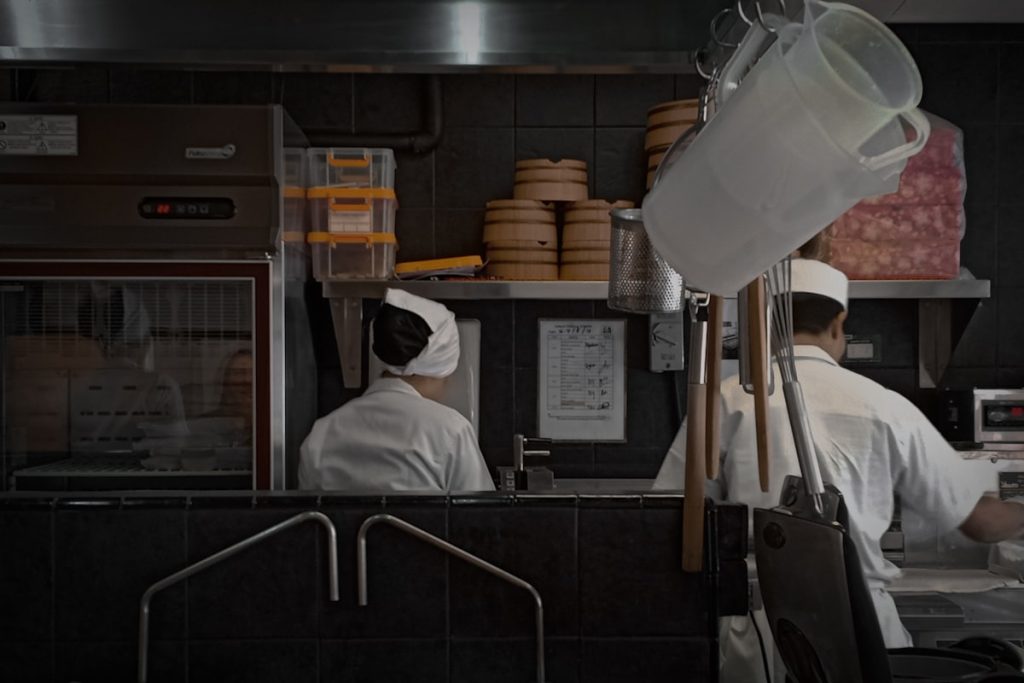 Two chefs working together in a professional kitchen