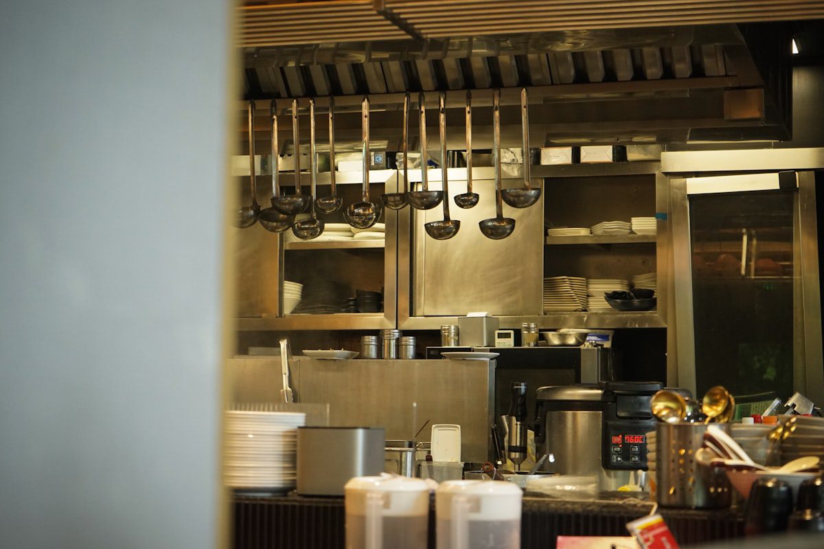 Kitchen utensils hanging in a professional restaurant kitchen