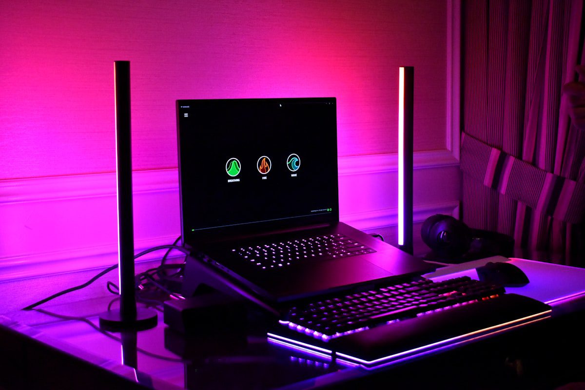 Gaming laptop setup with keyboard and RGB lighting