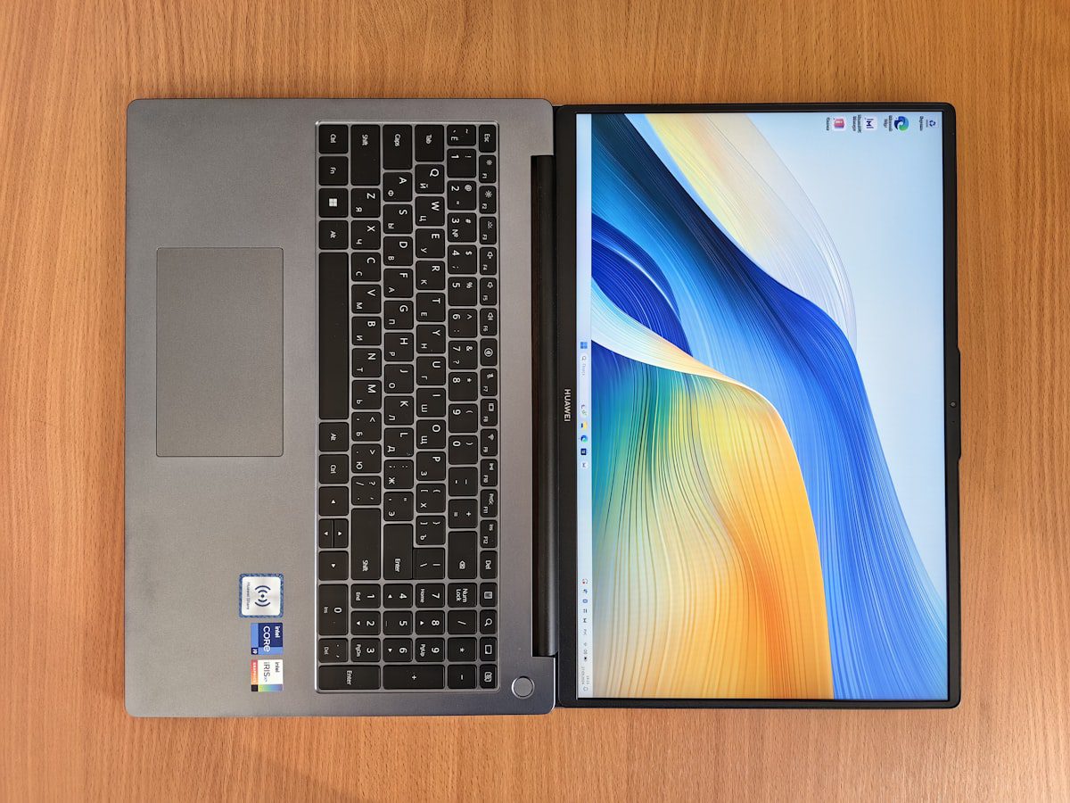 Laptop computer on a wooden desk for comparison