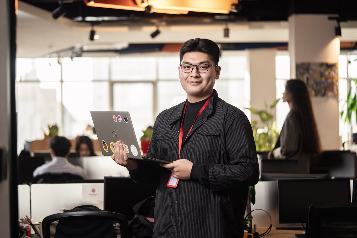 Person with laptop in a modern office environment