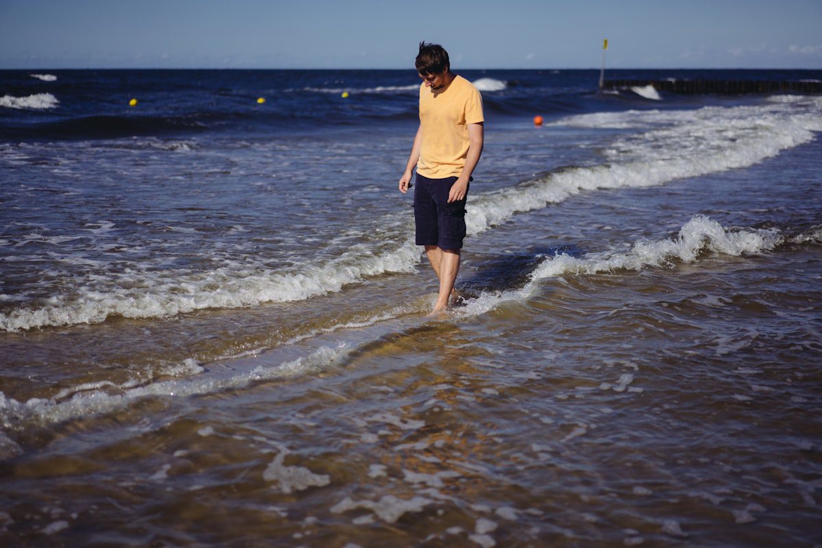 man standing at beach during daytime
