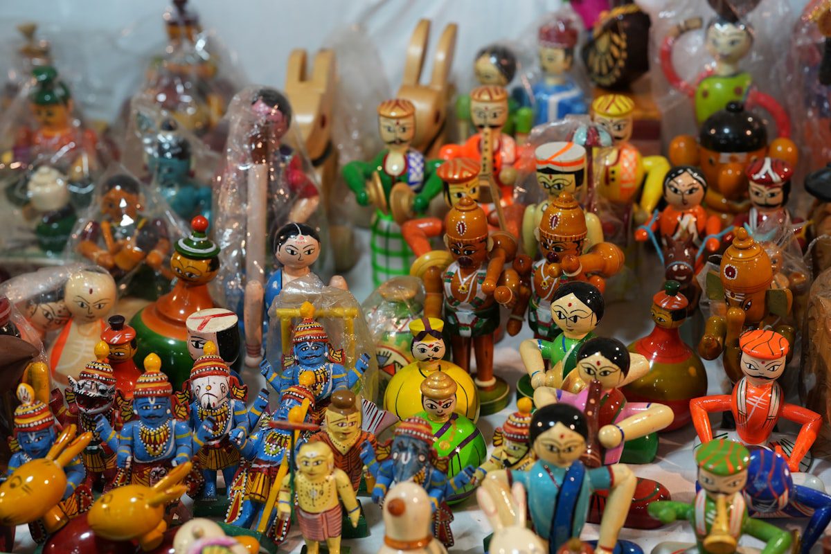 Colorful handmade wooden dolls and toys at a craft market
