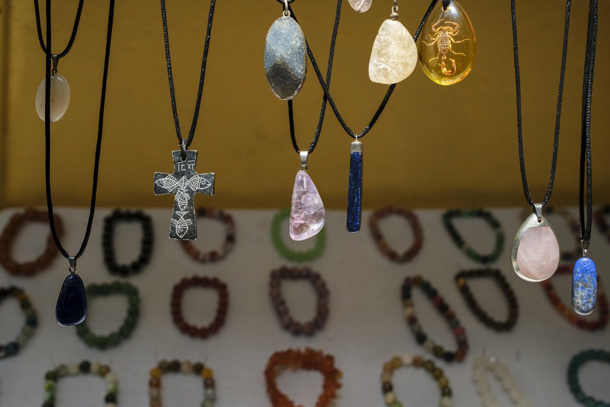 Assortment of artisan necklaces with colorful pendants on display