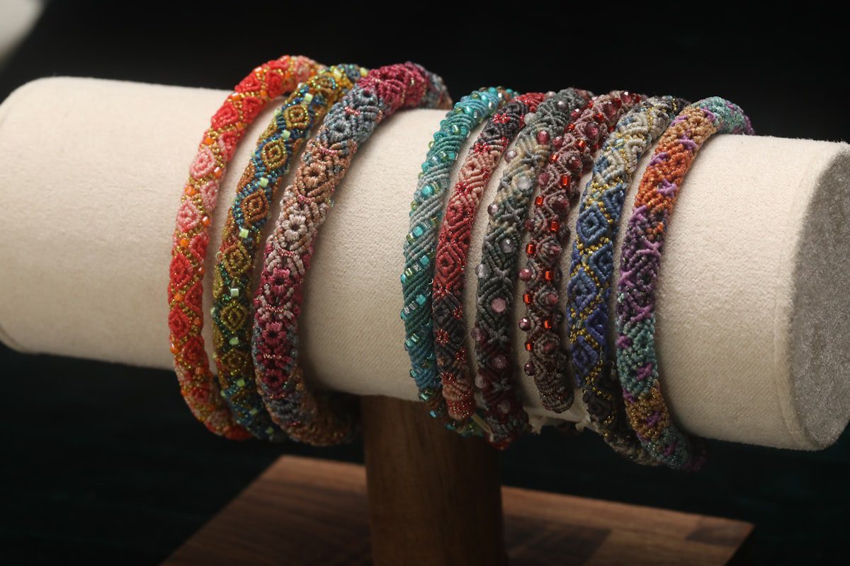 Assortment of colorful beaded bracelets displayed on a stand